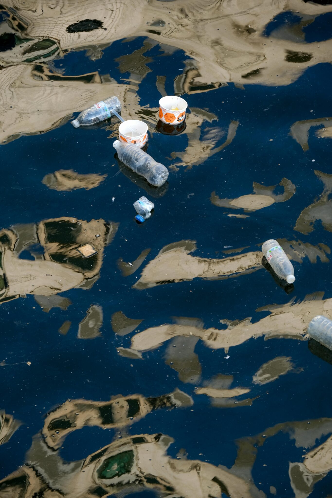 Floating plastic waste in water highlighting environmental pollution.
